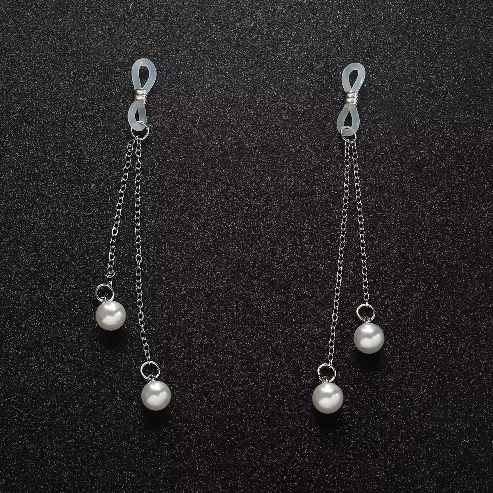 Elegant pearl dangle fake piercing nipple jewelry displayed beautifully on a textured black background, showcasing the minimalist indie aesthetic.